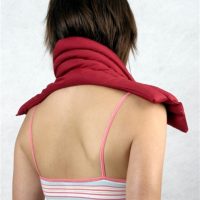 woman with heat pack on shoulders