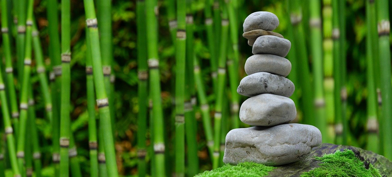 stacking rocks with bamboo background